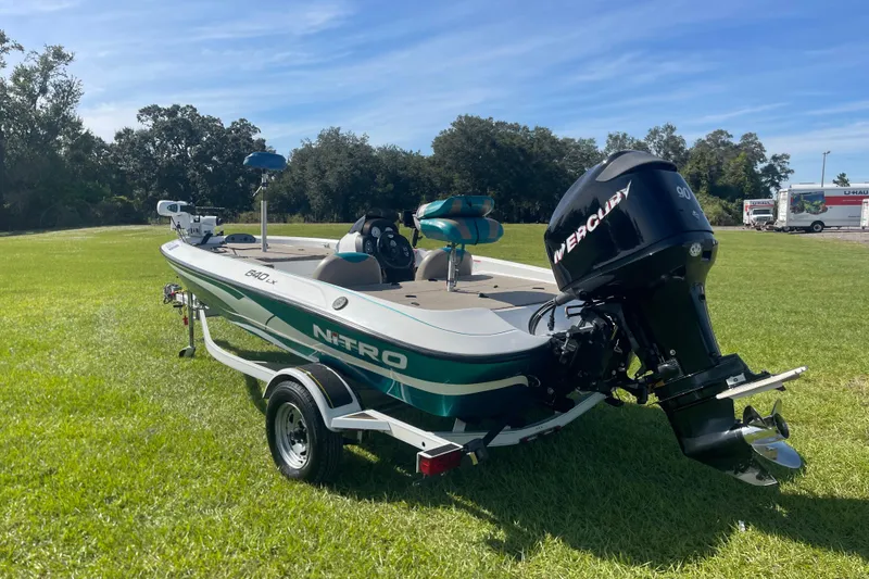 Slide: The Image of 2006 Nitro 640 LX boat with Mercury engine on grassy field. - 4