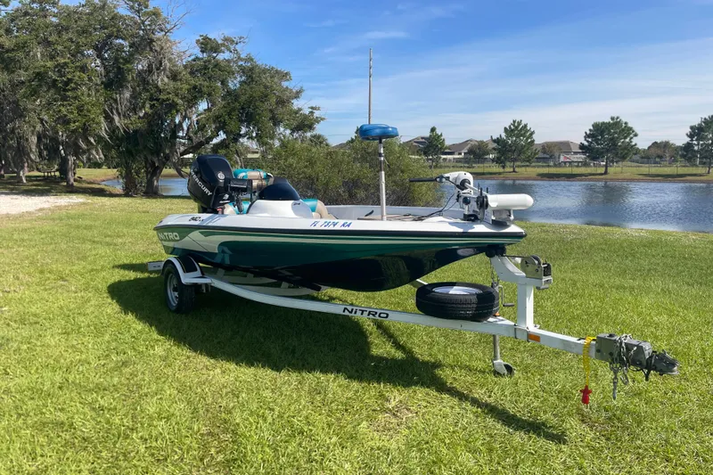 Slide: The Image of 2006 Nitro 640 LX boat on trailer by a scenic lake. - 6