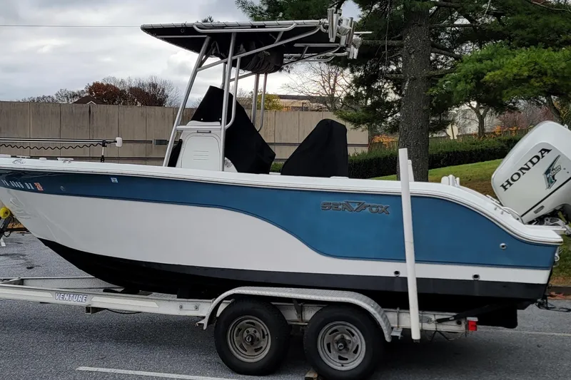 Slide: The Image of 2010 Sea Fox 216 Center Console boat on trailer with Honda outboard motor. - 0