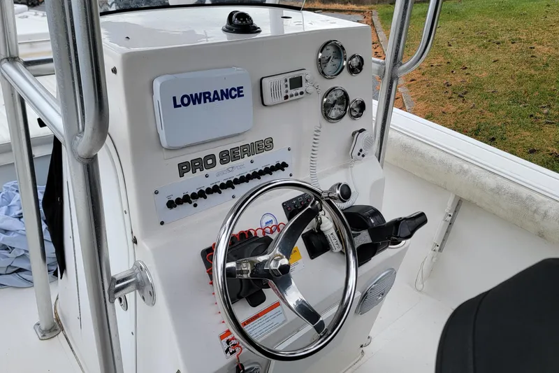 Slide: The Image of 2010 Sea Fox 216 Center Console boat dashboard with steering wheel and gauges. - 10