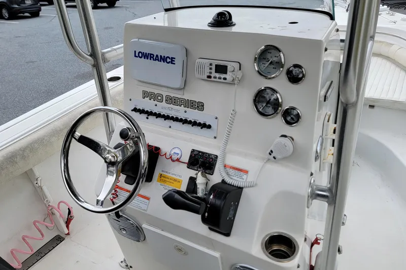 Slide: The Image of Control panel of a 2010 Sea Fox 216 Center Console boat with steering wheel and gauges. - 11