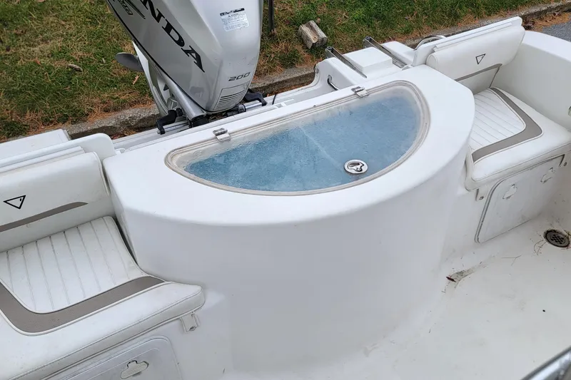 Slide: The Image of 2010 Sea Fox 216 Center Console boat interior with Honda engine and seating. - 13