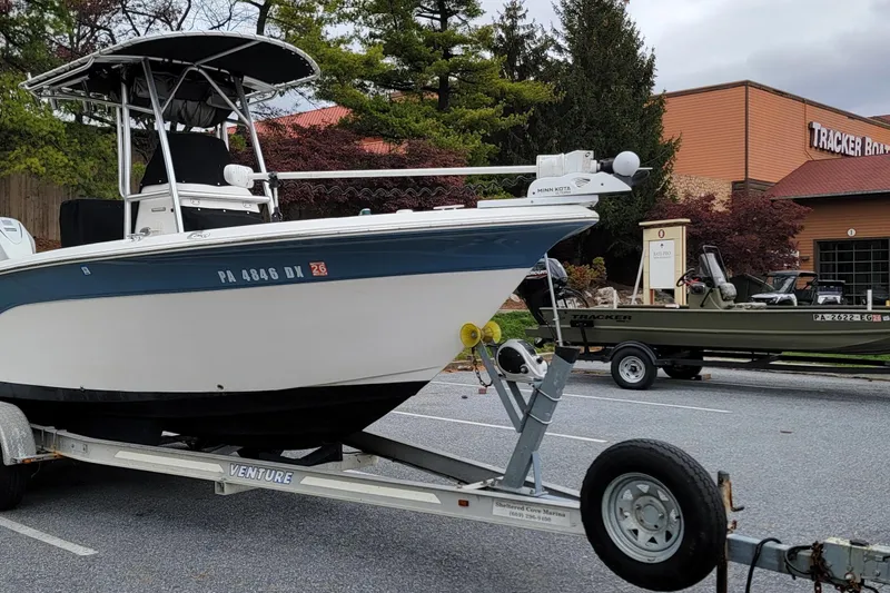 Slide: The Image of 2010 Sea Fox 216 Center Console boat on trailer in parking lot near Tracker Boats building. - 2