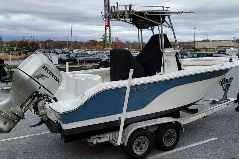 Slide: The Image of 2010 Sea Fox 216 Center Console boat with Honda outboard motor on trailer. - 3