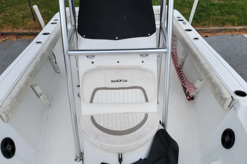 Slide: The Image of 2010 Sea Fox 216 Center Console interior with seating and rod holders. - 7