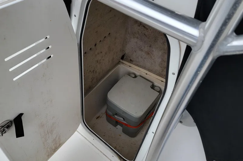 Slide: The Image of 2010 Sea Fox 216 Center Console storage compartment with portable toilet. - 8