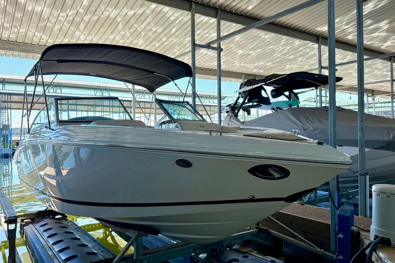 Slide: The Image of 2010 Cobalt 232 boat with canopy in covered dock. - 15