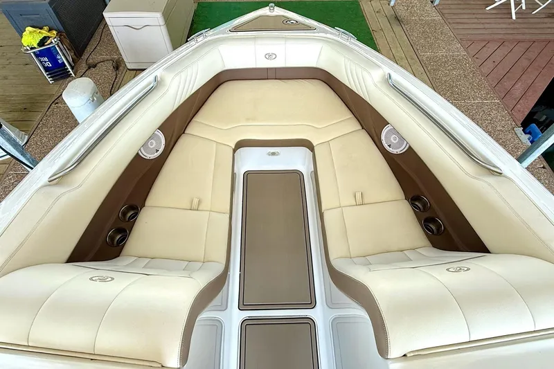 Slide: The Image of Luxurious interior of a 2010 Cobalt 232 boat with beige seating and cup holders. - 25