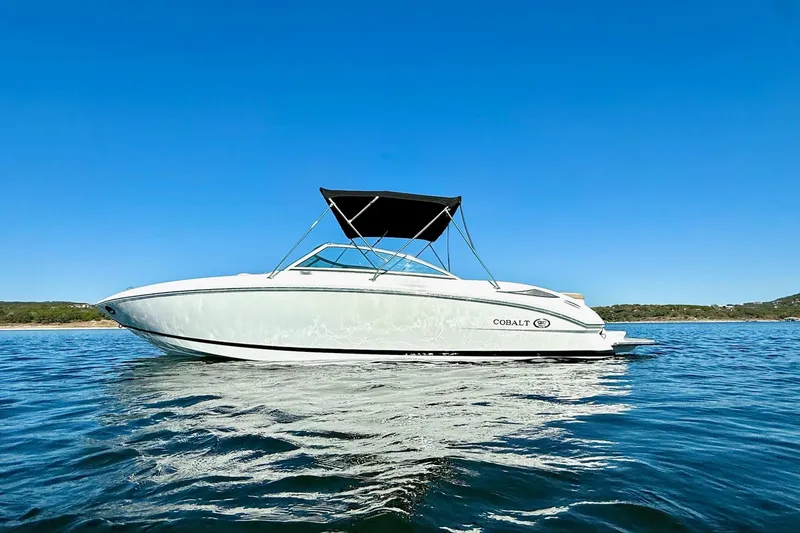 Slide: The Image of 2010 Cobalt 232 boat cruising on clear blue water under a sunny sky. - 3
