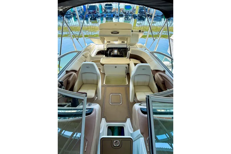 Slide: The Image of 2010 Cobalt 232 boat interior with beige seating and open deck layout. - 30