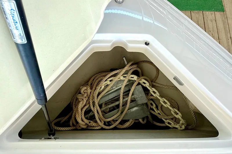 Slide: The Image of Anchor and rope storage in 2010 Cobalt 232 boat compartment. - 34