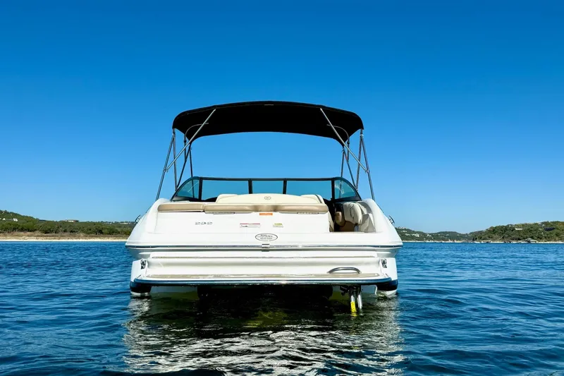 Slide: The Image of 2010 Cobalt 232 boat on calm water under clear blue sky. - 5