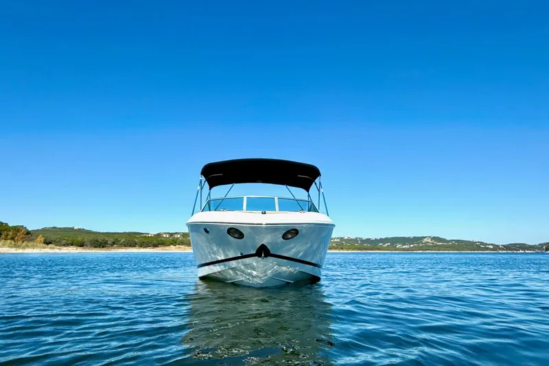 Slide: The Image of 2010 Cobalt 232 boat on calm water under clear blue sky. - 9