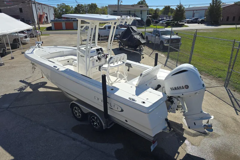Slide: The Image of 2019 Robalo 246 Cayman boat with Yamaha engine on trailer in a parking lot. - 10