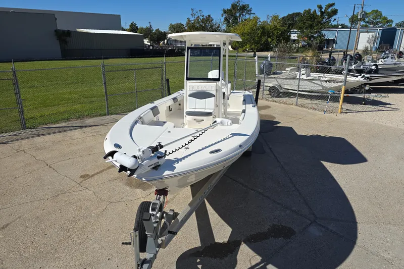 Slide: The Image of 2019 Robalo 246 Cayman boat on trailer, parked outdoors in a fenced area. - 13