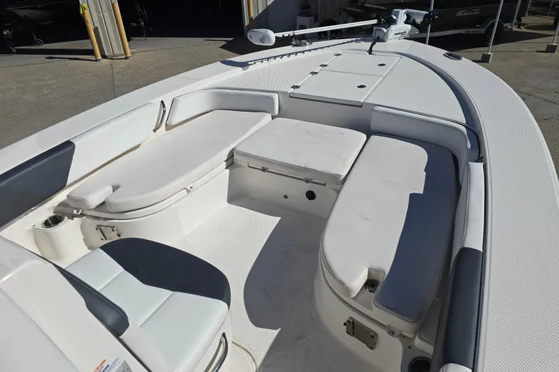 Slide: The Image of 2019 Robalo 246 Cayman boat interior with cushioned seating and storage compartments. - 15