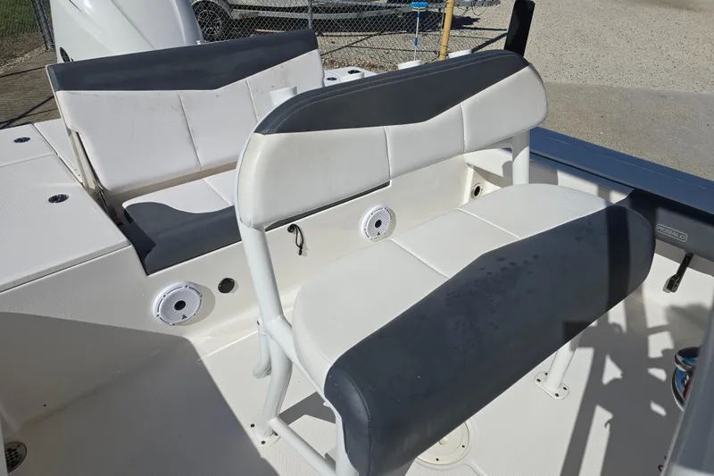 Slide: The Image of 2019 Robalo 246 Cayman boat seating area with white and gray upholstery. - 17