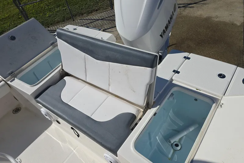 Slide: The Image of 2019 Robalo 246 Cayman boat interior with seating and storage compartments. - 19