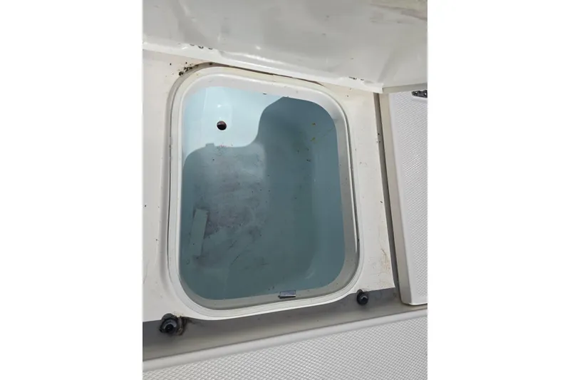 Slide: The Image of 2019 Robalo 246 Cayman boat storage compartment, open and empty. - 24