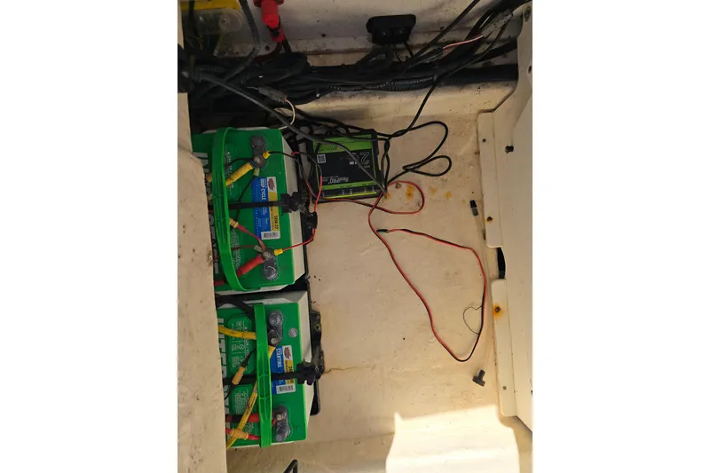 Slide: The Image of Battery compartment of a 2019 Robalo 246 Cayman boat with wiring and connections. - 26