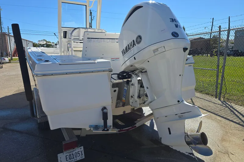 Slide: The Image of 2019 Robalo 246 Cayman boat with Yamaha 300 V6 outboard motor, parked outdoors. - 3
