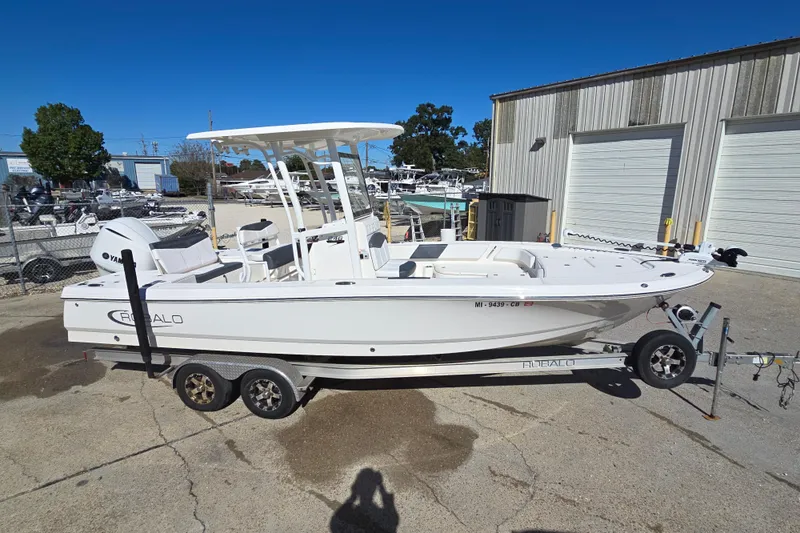 Slide: The Image of 2019 Robalo 246 Cayman boat on trailer, parked outdoors near storage facility. - 7