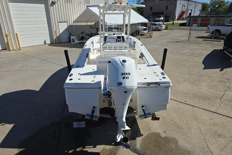 Slide: The Image of 2019 Robalo 246 Cayman boat with 300 V6 engine, parked outdoors. - 9