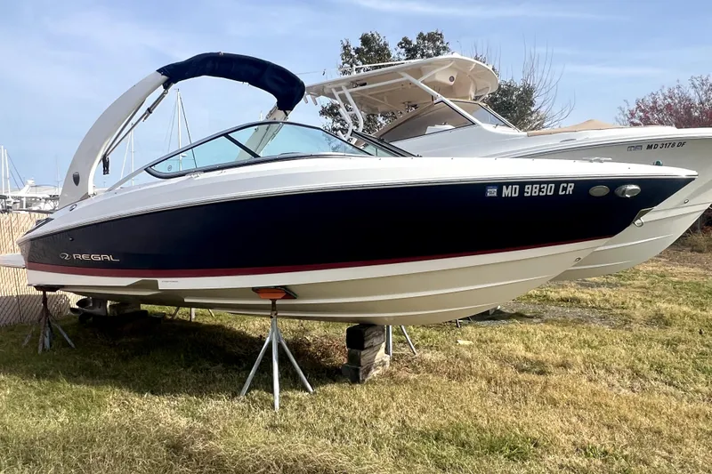 Slide: The Image of 2016 Regal 2300 Bowrider boat on stands, displayed outdoors. - 1