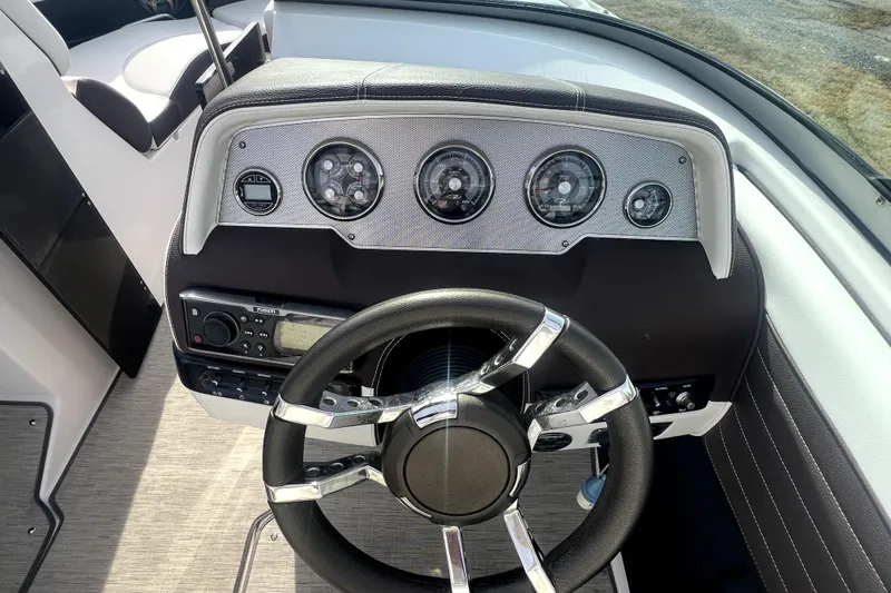Slide: The Image of Steering console of a 2016 Regal 2300 Bowrider boat with gauges and controls. - 10