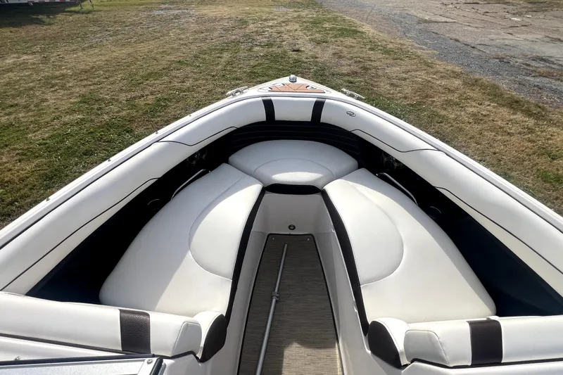 Slide: The Image of 2016 Regal 2300 Bowrider boat interior with white cushioned seating. - 7