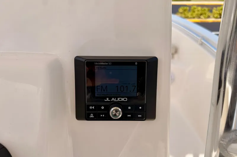 Slide: The Image of JL Audio MediaMaster 50 radio on 2023 Cobia 220 Center Console boat dashboard. - 18