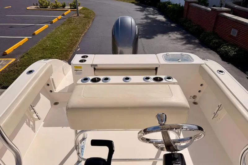 Slide: The Image of 2023 Cobia 220 Center Console boat interior with steering wheel and seating area. - 21