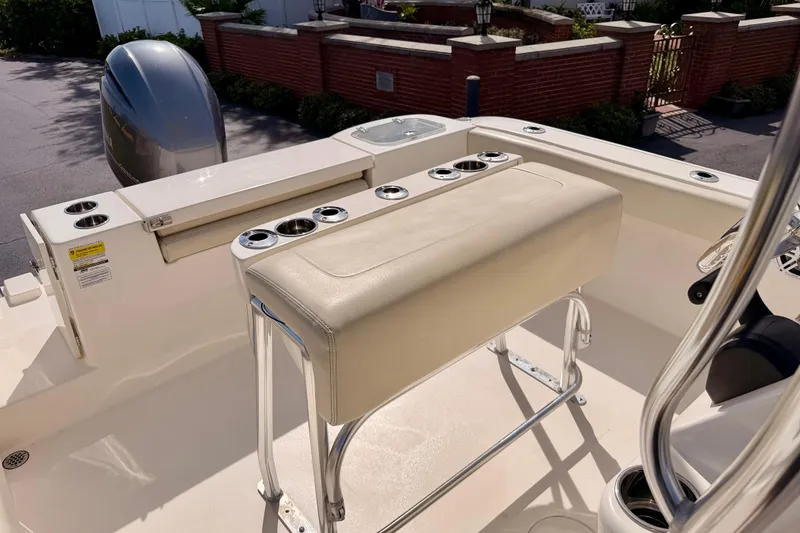 Slide: The Image of 2023 Cobia 220 Center Console boat interior with seating and rod holders. - 22