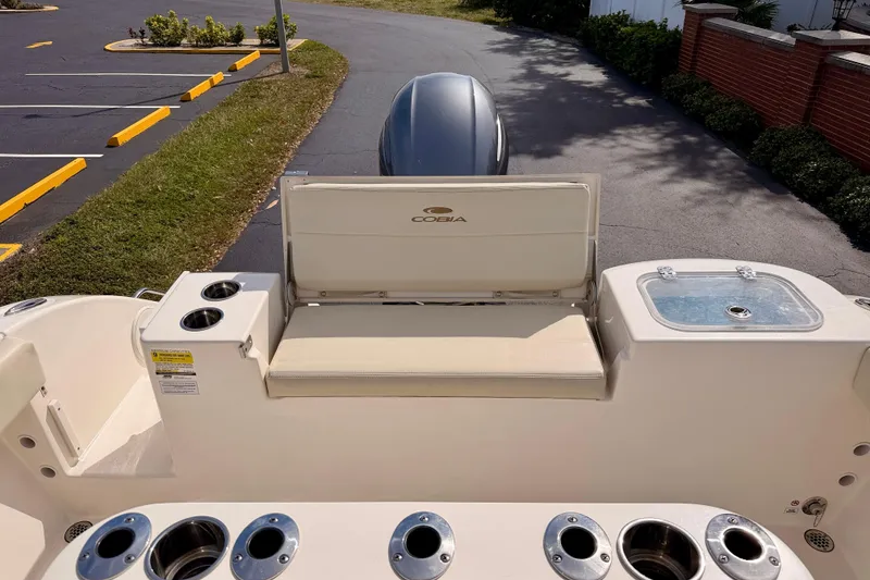 Slide: The Image of 2023 Cobia 220 Center Console boat interior with seating and cup holders. - 25
