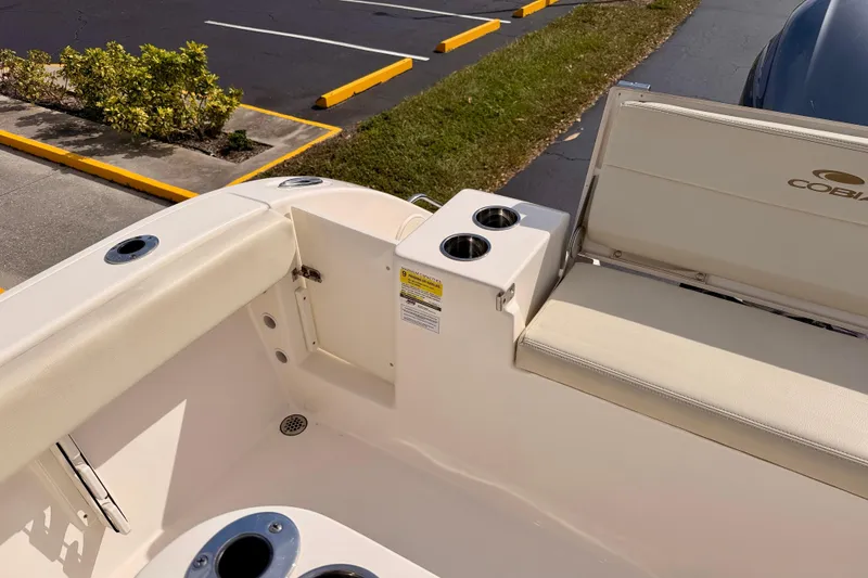 Slide: The Image of 2023 Cobia 220 Center Console boat interior with seating and cup holders. - 28