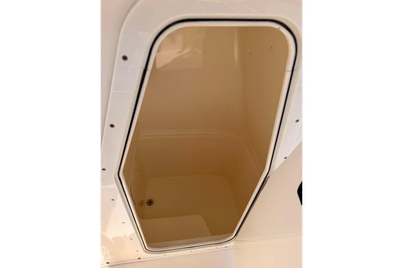 Slide: The Image of Storage compartment on 2023 Cobia 220 Center Console boat, featuring a sleek interior design. - 29