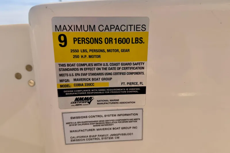 Slide: The Image of 2023 Cobia 220 Center Console capacity label, 9 persons or 1600 lbs, safety compliance. - 30