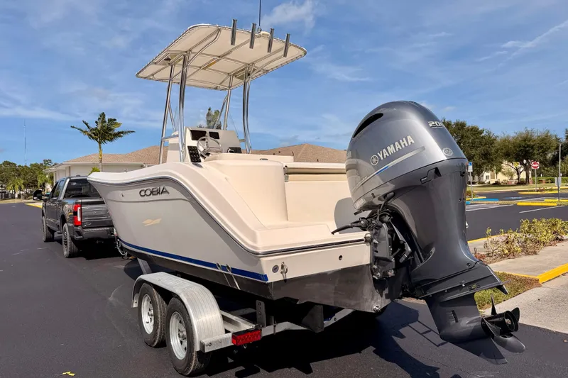 Slide: The Image of 2023 Cobia 220 Center Console boat with Yamaha engine on trailer. - 6