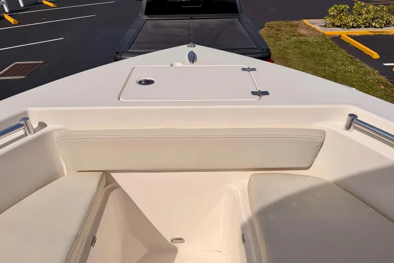 Slide: The Image of 2023 Cobia 220 Center Console boat interior with seating and storage. - 9