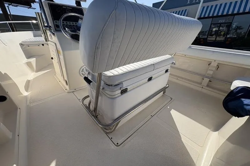 Slide: The Image of 2004 Key West 186 Sportsman boat interior with cushioned seating and steering console. - 11