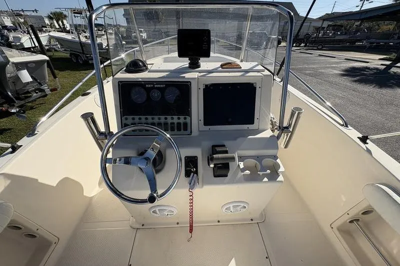 Slide: The Image of 2004 Key West 186 Sportsman boat dashboard with steering wheel and controls. - 15