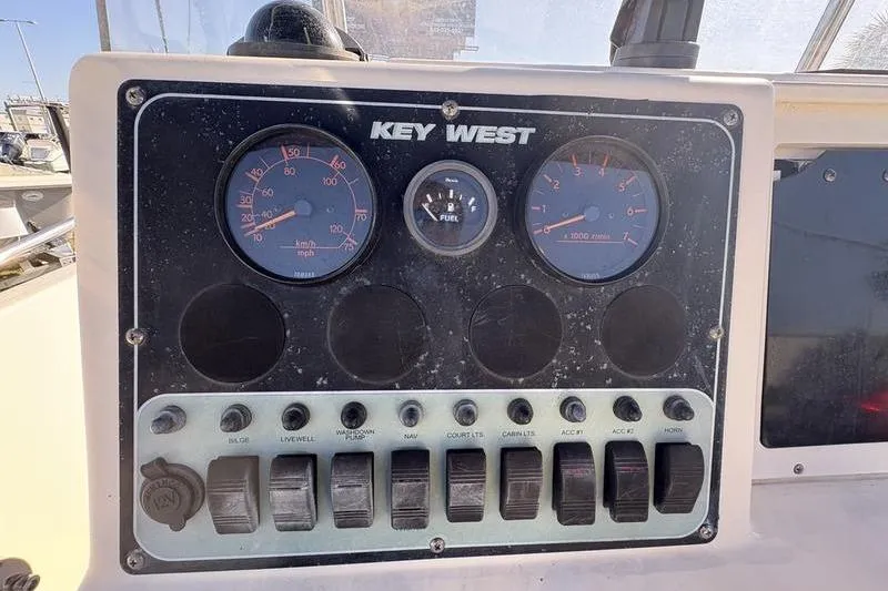 Slide: The Image of Dashboard of a 2004 Key West 186 Sportsman boat with gauges and switches. - 16