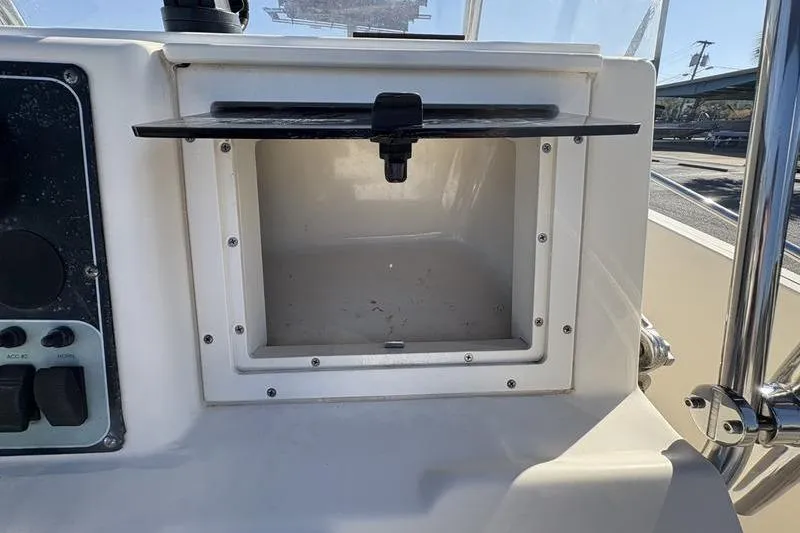 Slide: The Image of Open storage compartment on 2004 Key West 186 Sportsman boat dashboard. - 17