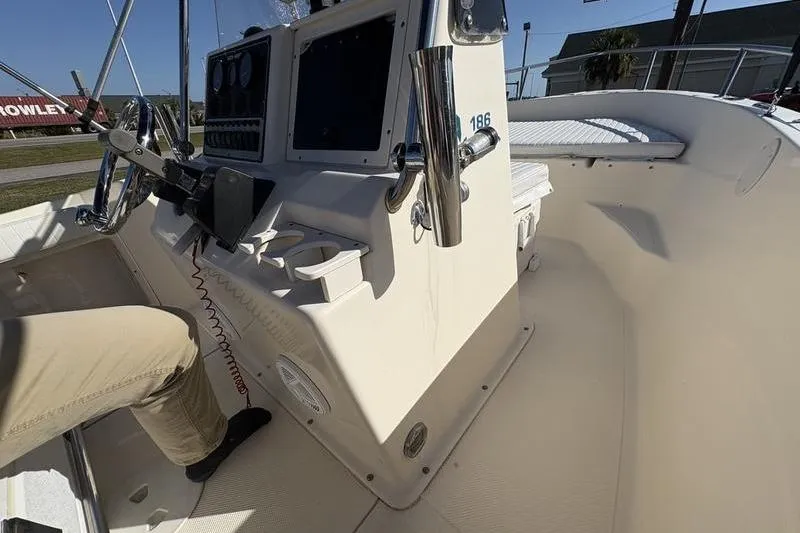 Slide: The Image of 2004 Key West 186 Sportsman boat interior with steering console and seating area. - 19
