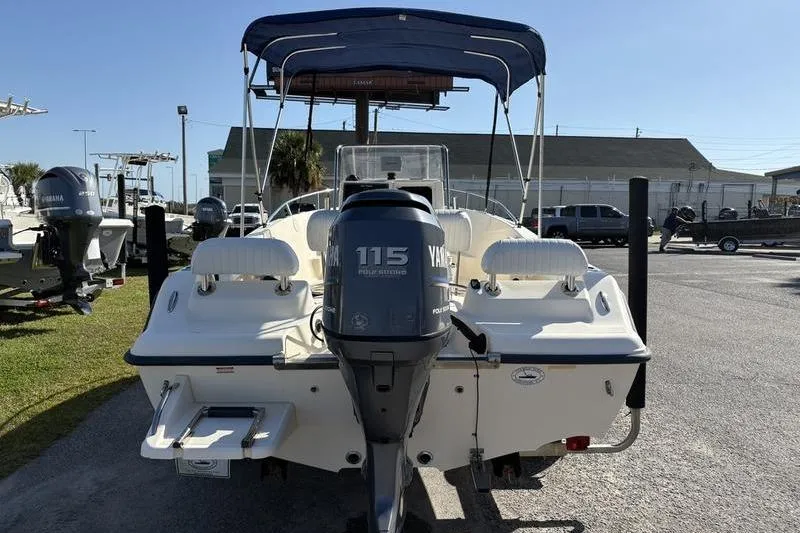 Slide: The Image of 2004 Key West 186 Sportsman boat with Yamaha 115 engine, parked outdoors. - 2