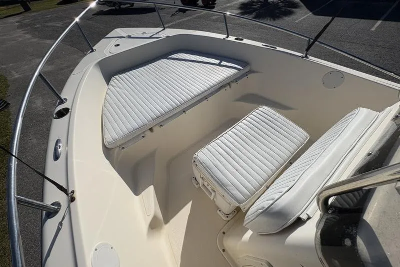 Slide: The Image of 2004 Key West 186 Sportsman boat with white cushioned seating in the bow area. - 22