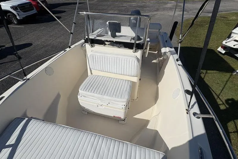 Slide: The Image of 2004 Key West 186 Sportsman boat interior with white seating and console. - 23