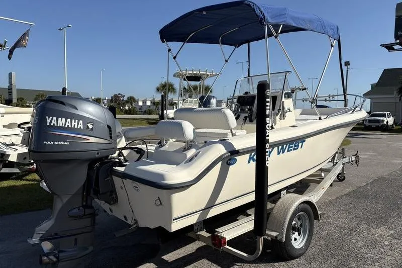 Slide: The Image of 2004 Key West 186 Sportsman boat with Yamaha engine on trailer, blue canopy. - 3