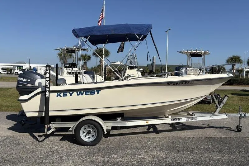 Slide: The Image of 2004 Key West 186 Sportsman boat on trailer with blue canopy and Yamaha motor. - 5