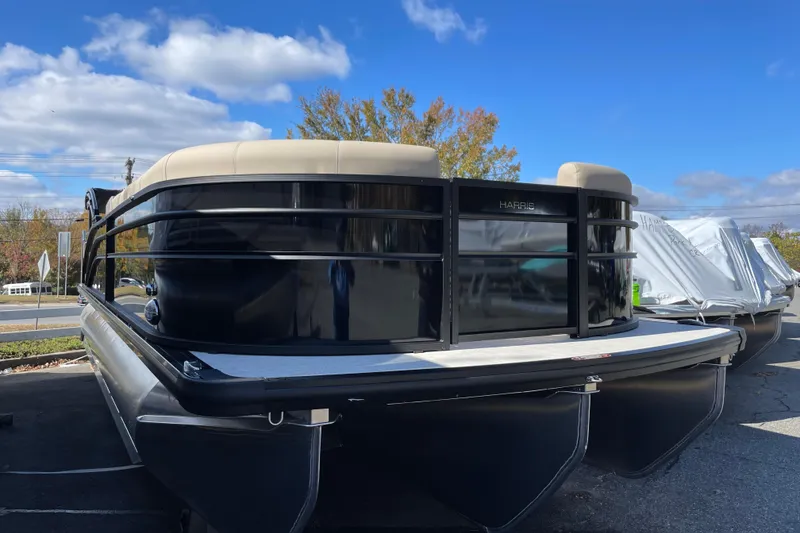 The Image of 2026 Harris Cruiser 250 pontoon boat under clear blue sky. - 1